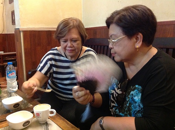 4 Clients from the Philippines are having Vietnamese coffee on their north Vietnam travel Hanoi