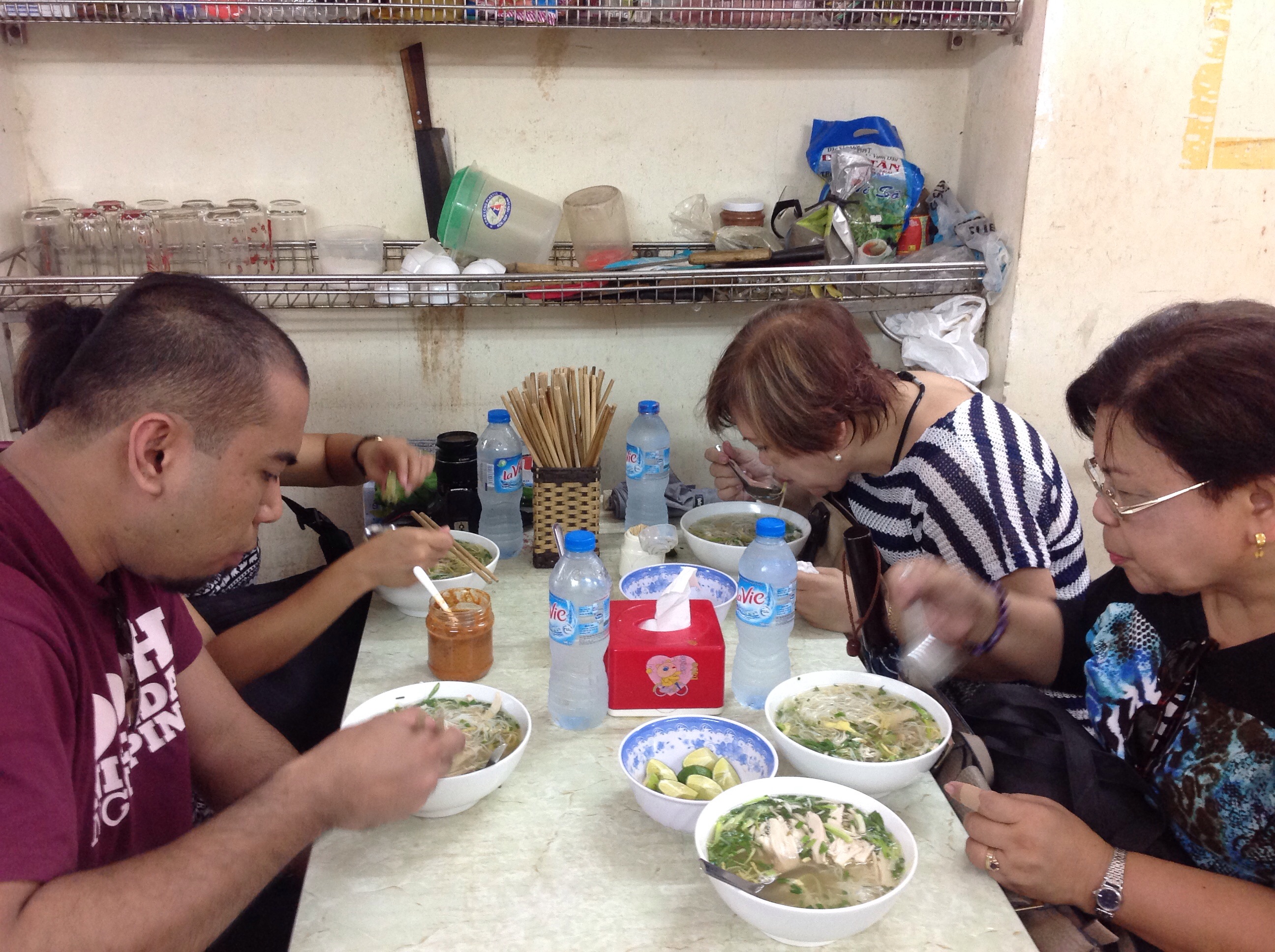 4 Clients from the Philippines are having Pho Ga - Chicken noolde soup on their north Vietnam tour Hanoi to Halong bay  