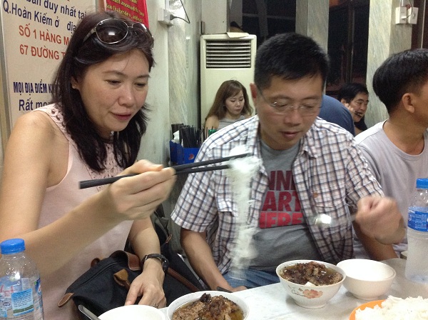 Mrs. Khoo ate Bun Cha on their Hanoi travel holiday with us. They love it so much